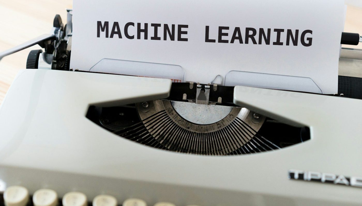 a close up of a typewriter with a paper reading machine learning