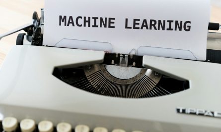 a close up of a typewriter with a paper reading machine learning